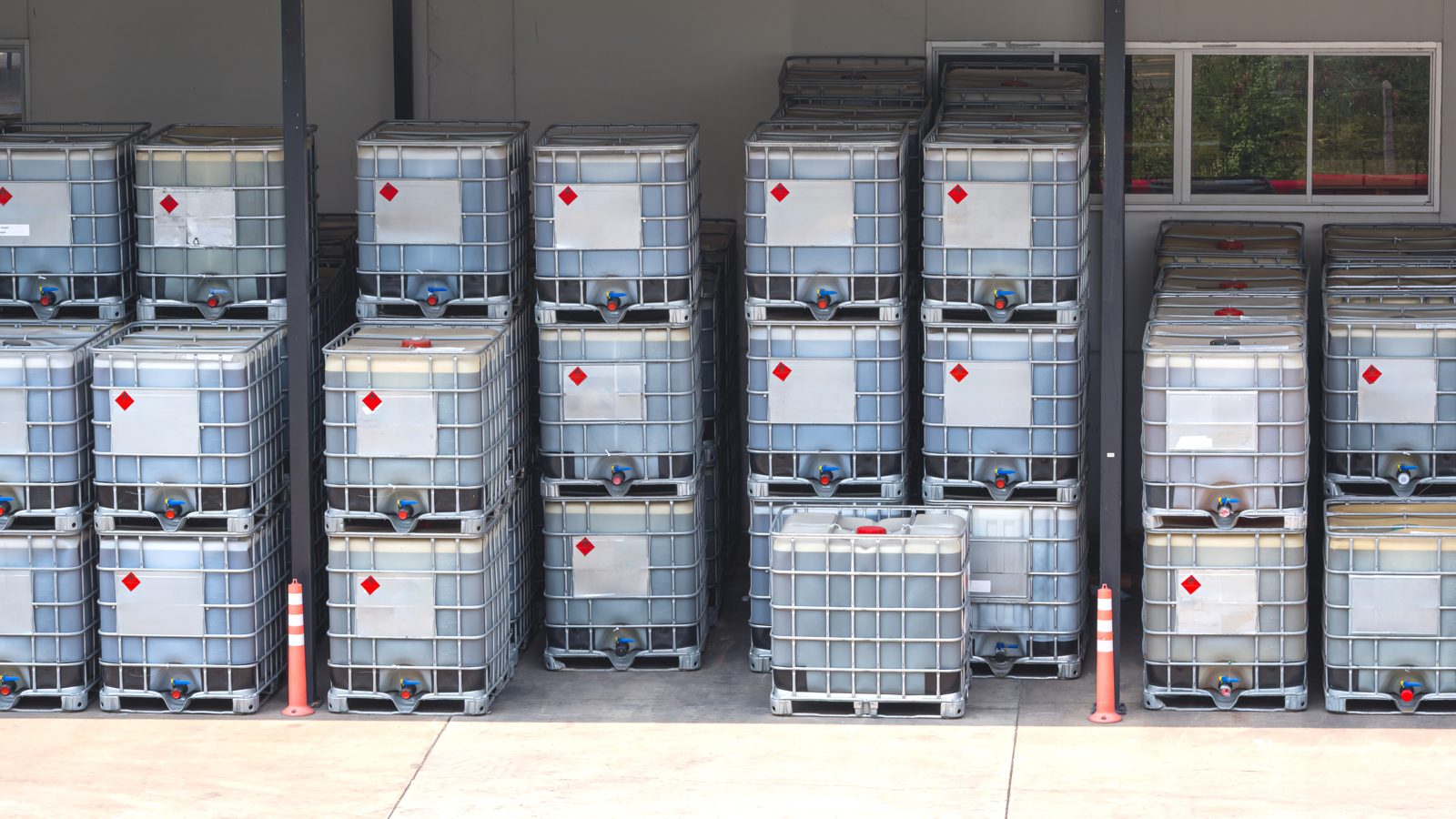 Rows of intermediate bulk containers at a chemical supplier facility