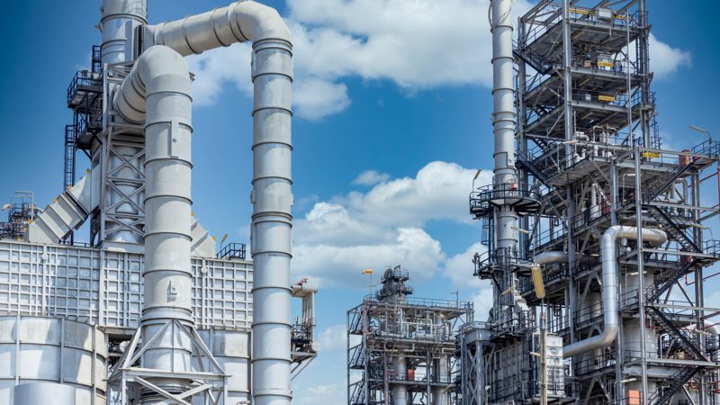 Industrial plant structures against a blue sky
