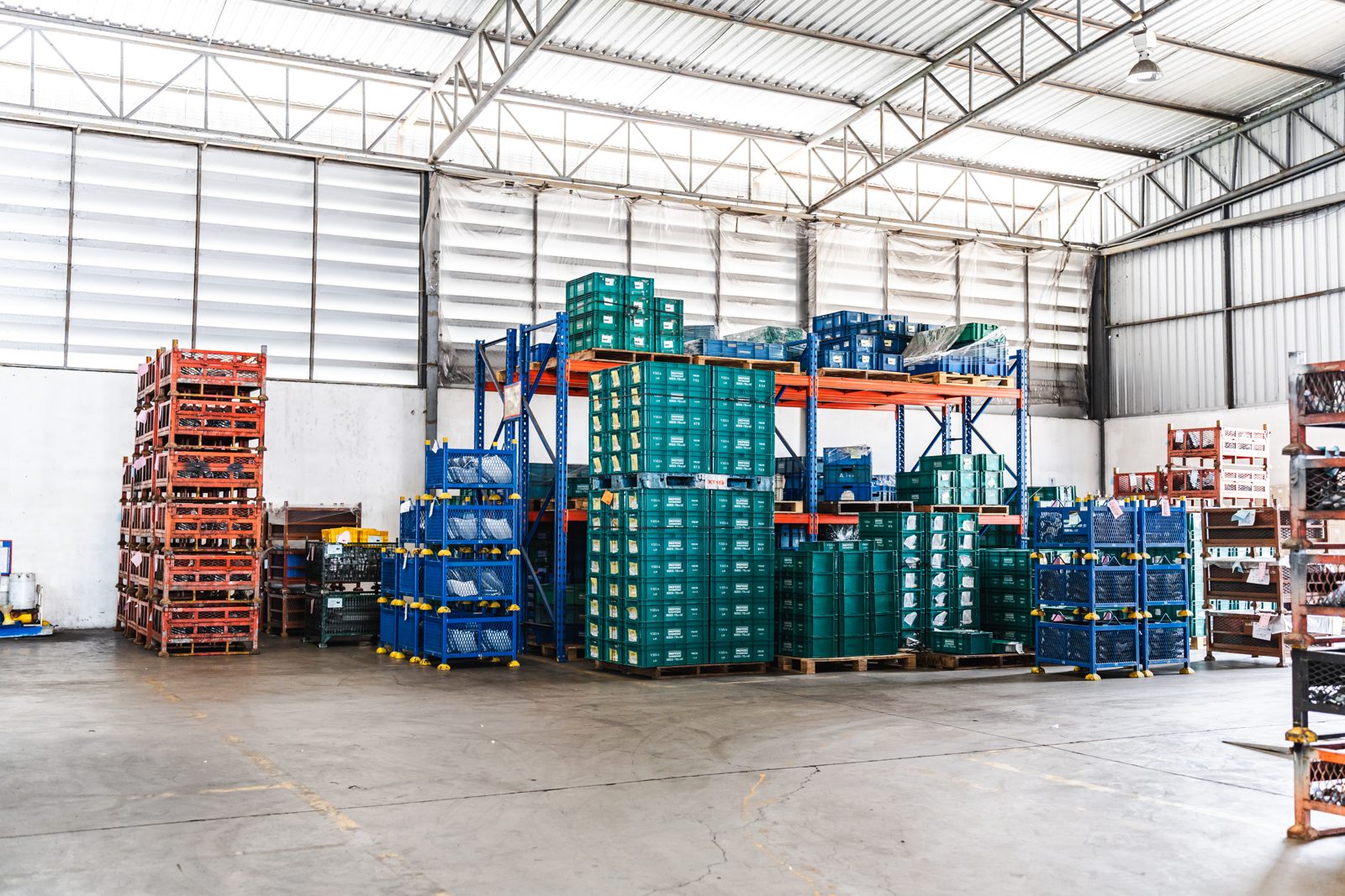 Stacked containers on warehouse shelves, representing surplus stock listed by Premium suppliers